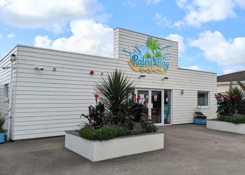 a building with a sign for a restaurant at Monkey Tree Holiday Park in Newquay
