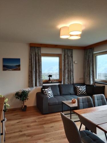 a living room with a couch and a table at Apart Bergauf in Rohrberg