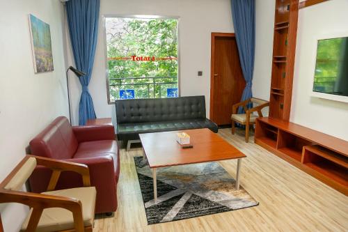 a living room with a couch and a table at Hotel Totara in Dar es Salaam