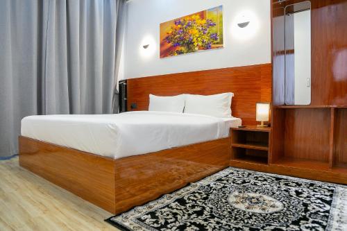 a hotel room with a bed and a television at Hotel Totara in Dar es Salaam