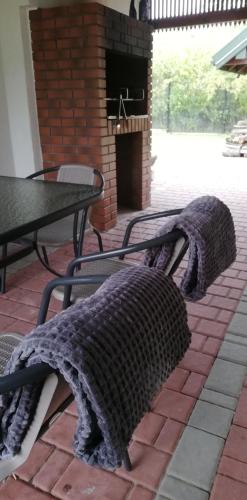 a blanket sitting on a bench in a patio at Domek Chmiel I nad Jeziorem Tarnobrzeskim in Chmielów