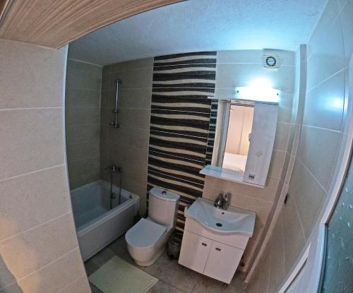 a bathroom with a sink and a toilet and a tub at Atillas Getaway in Selçuk