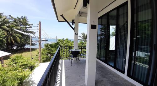 a balcony with a view of the ocean at Magic House - No Pets Allowed in Chumphon