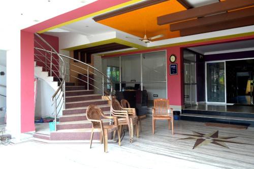 a group of chairs and a table in front of a building at hotel sagnik in Murshidābād