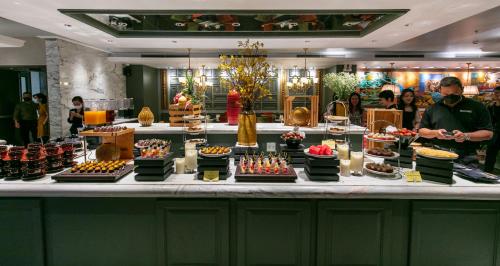 a buffet with many different types of cakes and desserts at Peridot Grand Luxury Boutique Hotel in Hanoi