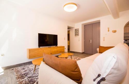 a living room with a couch and a tv at Mystras Residence Ground Floor in Mystras