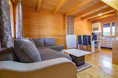 a living room with a couch and a table at Zlatibor Brvnara Mir in Zlatibor