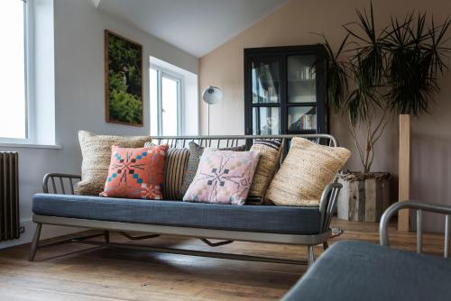 a couch with pillows on it in a living room at Swn Y Don in Haverfordwest
