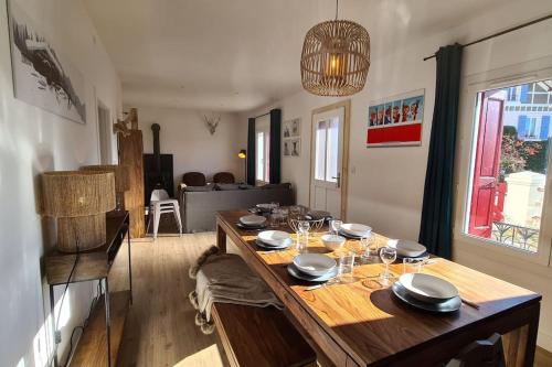 a dining room table with plates and wine glasses on it at La Fario - Grande maison familiale in Font-Romeu-Odeillo-Via