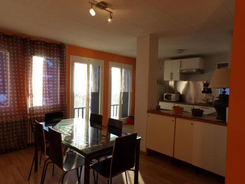 a kitchen and dining room with a table and chairs at Hotel Roc de St Miquel & Apartment in Soldeu