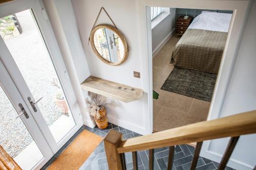 a hallway with a mirror on the wall and a bed at Swn Y Don in Haverfordwest