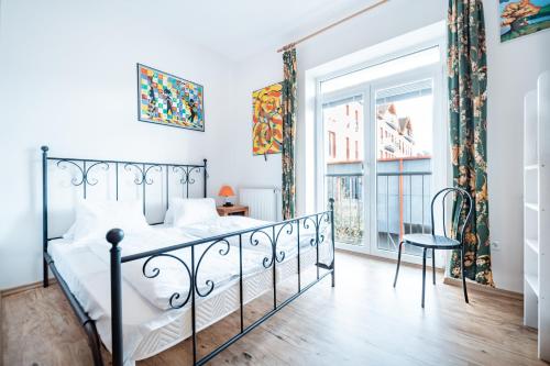 a bedroom with a bed and a window at Club Canada Lipno De Luxe in Lipno nad Vltavou