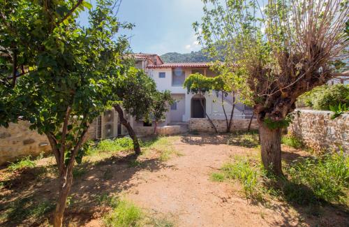 a house with trees in front of it at Mystras Residence Upper Floor in Mystras