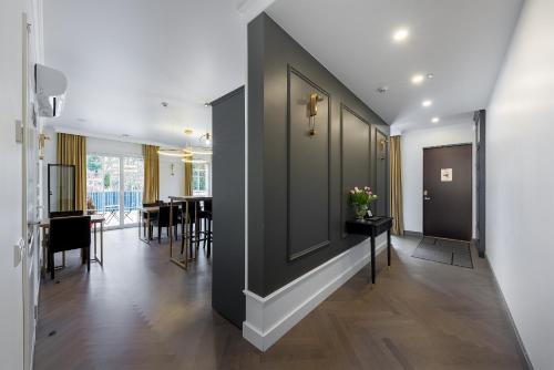 a hallway with black walls and a table with flowers at Vilnius legends house I Best for families I Free parking in Vilnius