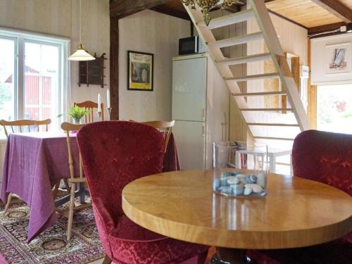 a dining room with a table and a staircase at En lantlig idyll med skogen precis utanför dörren! in Ullared