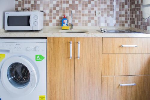 a kitchen with a washing machine and a sink at Feyza Apart in Istanbul