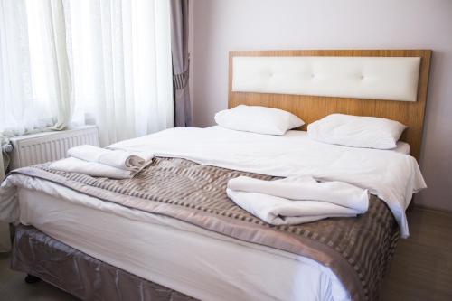 a bedroom with two beds with white towels on them at Feyza Apart in Istanbul