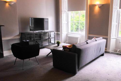 a living room with a couch and a tv at Leevin Studios in Dublin