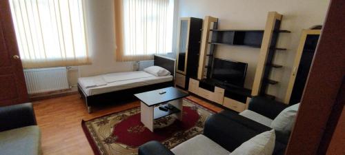 a living room with a couch and a tv at Arena Hotel Balakan in Balakǝn