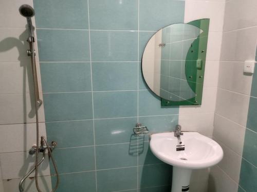 a bathroom with a sink and a mirror at Arena Hotel Balakan in Balakǝn