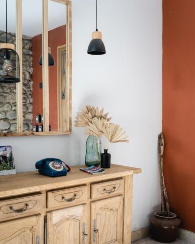 a kitchen with a wooden cabinet and a mirror at Le Patio - Vallée d'Aspe in Bedous