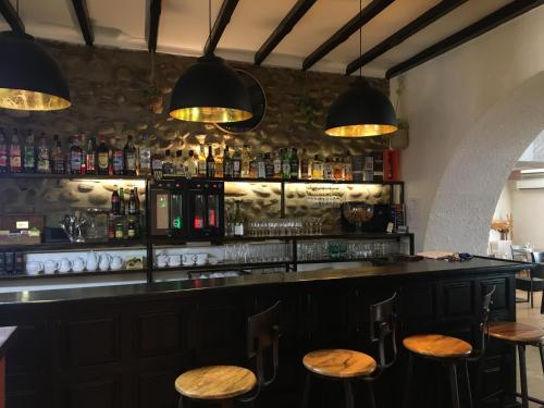 a bar with wooden stools in a room at Logis Hôtel de France & Restaurant Pamiers in Pamiers