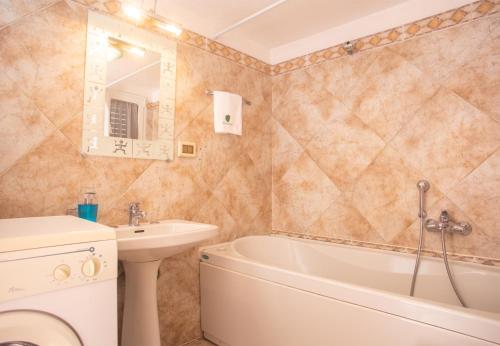 une salle de bain avec un lavabo, une baignoire et des toilettes dans l'établissement Casa Zefiro - The Fab Stay, à Ostuni