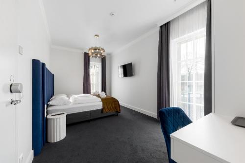 a bedroom with a bed and a large window at Vilnius legends house I Best for families I Free parking in Vilnius