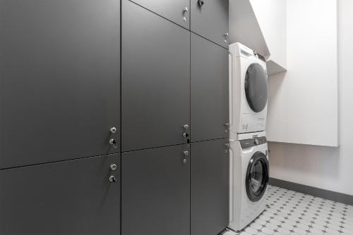 a kitchen with a washing machine and a microwave at Vilnius legends house I Best for families I Free parking in Vilnius