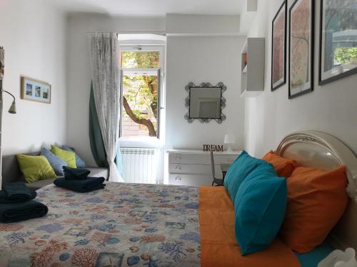 a bedroom with a bed and a television and a window at Rivabahn in Trieste