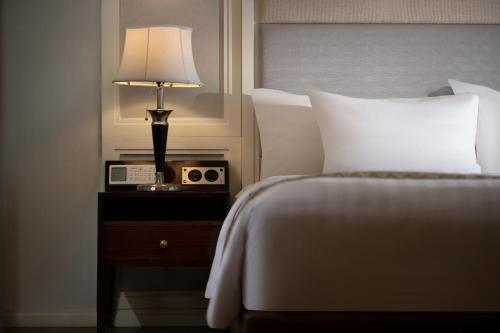 a bedroom with a bed and a lamp on a night stand at Wyndham Panbil Batam in Batam Center