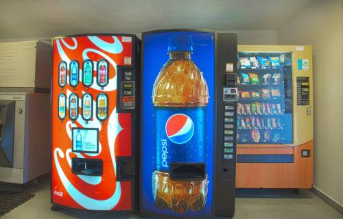 a cocacola bottle next to a soda machine at North Charleston Lodge in Charleston