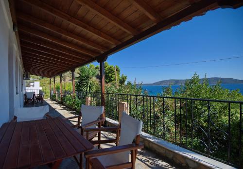 a porch of a house with a table and chairs at Thea Studios in Kalamakia