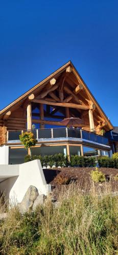 a house with a wooden roof on top of it at Hideaway Zugspitz Berwang in Berwang