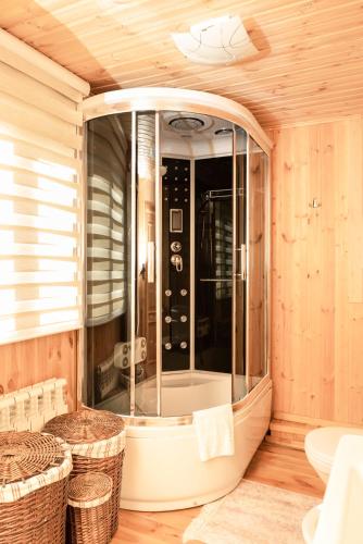 a bathroom with a large shower with wicker baskets at Forest resort BalQaragai in Malotimofeyevka