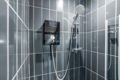 a shower with a blow dryer in a bathroom at 3 bedroom with parking by the station in Norwich