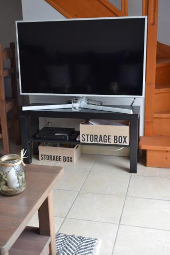 a flat screen tv sitting on top of a storage box at location maison à Cajarc 46160 (Lot) in Cajarc