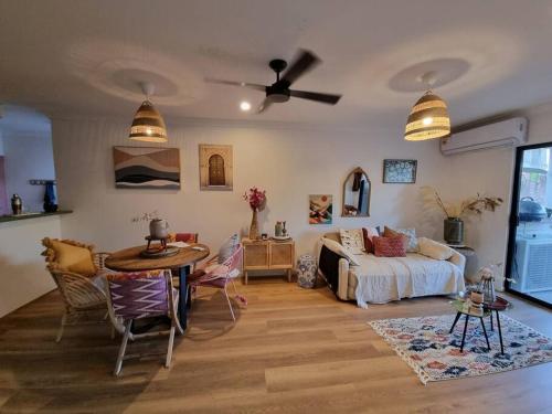 a living room with a bed and a table at Midnights in Morocco in Brisbane