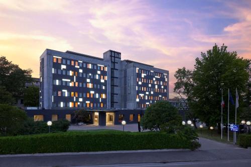 a large building with a sunset in the background at Best Western Park Hotel Continental in San Donà di Piave