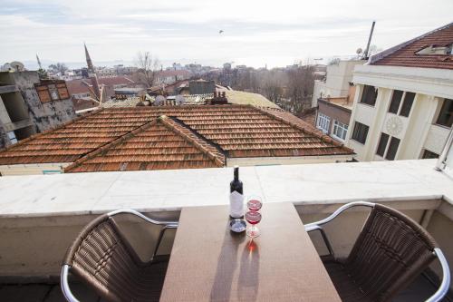 a bottle of wine sitting on a table on a balcony at Feyza Apart in Istanbul