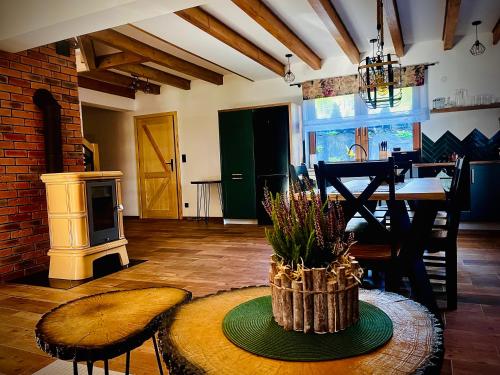 a living room with a table and a dining room at GABRA CHATA in Baligród