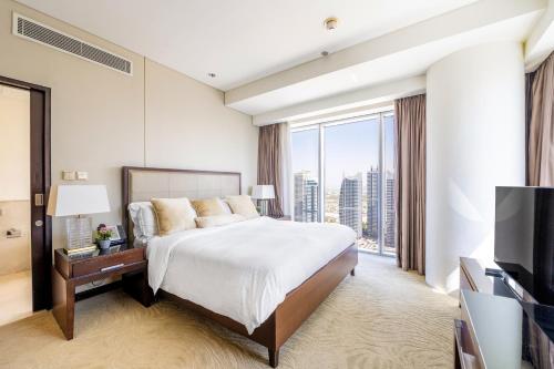 a hotel room with a bed and a large window at Address Dubai Marina - 1B Apt, Full Marina View with 5 Star Hotel Facilities by Gardenia Suites in Dubai