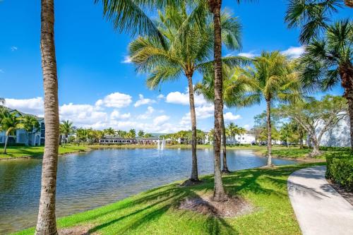 a view of a lake with palm trees at Tucker at Palm Trace Landings Fort Lauderdale in Davie