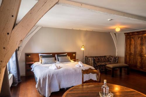 a bedroom with a large bed and a table at B&B Kwaadham 52 - Music Hotel Ghent in Ghent