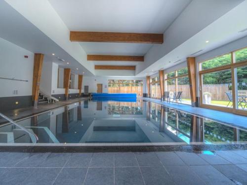 a large swimming pool in a large building at House 11 in Looe