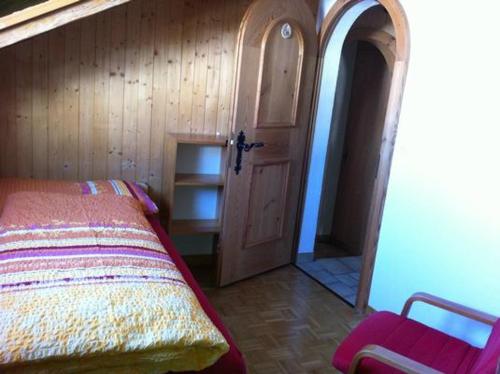 a bedroom with a bed and a wooden door at Plazzetta 23 in Sent