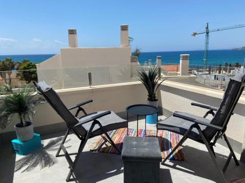 two chairs on a balcony with the ocean in the background at Casa puerto Isla Plana - Grande in Isla Plana