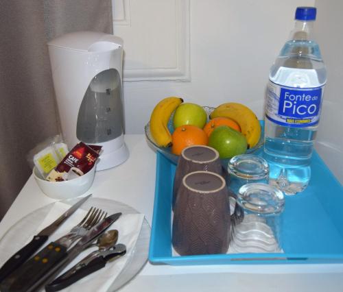 a blue tray filled with fruit and a bottle of water at Madeirarooms in Funchal