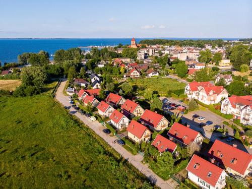 an aerial view of a town with houses and the ocean at Dom nad Zatoką in Puck