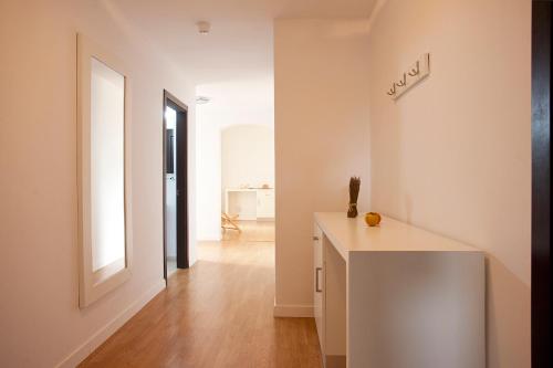 a white room with a counter and a hallway at Apartamentos Vista Alegre Mallorca in Porto Cristo